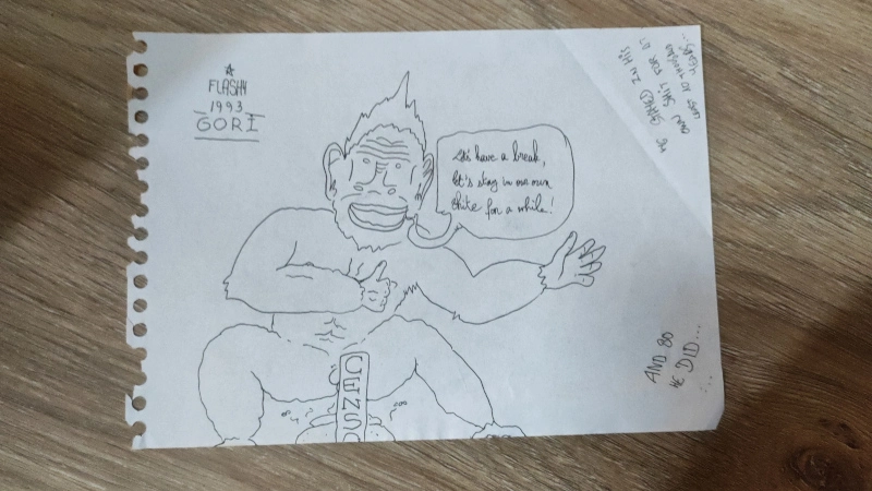 A smiling gorilla in black and white squats over his own excrement. He says :" Let's have a break, let's stay in our own shite for a while !" Around the animal, some text reads :"And so he did... He stayed in his own shit for a least ten thousand years..." Signed by Flashy 1993 Gori.